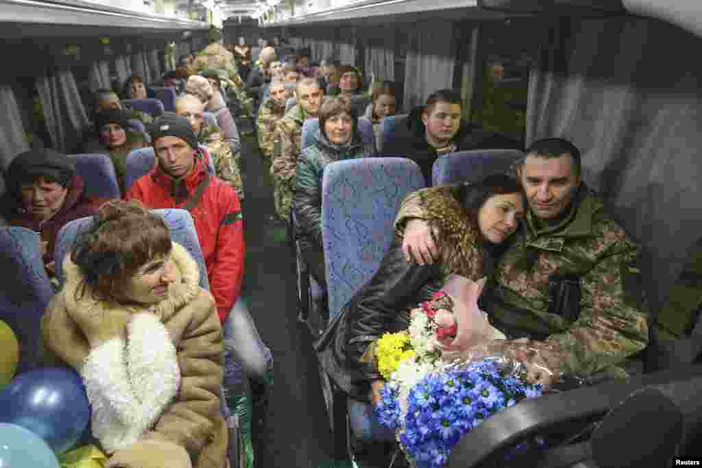 Recently exchanged prisoners of war (POWs) from the Ukrainian armed forces sit inside a bus upon their arrival at Boryspil International airport outside Kyiv, Ukraine.