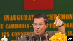 Cambodia's Prime Minister Hun Sen gestures as he delivers a speech during his presiding over an inauguration ceremony for the official use of a friendship bridge between Cambodia and China at Takhmau, Kandal provincial town south of Phnom Penh, Cambodia, Monday, Aug. 3, 2015.