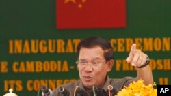 FILE: Cambodia's Prime Minister Hun Sen gestures during a speech at an inauguration ceremony for the official use of a friendship bridge between Cambodia and China at Takhmau, Kandal provincial town south of Phnom Penh, Cambodia, Monday, Aug. 3, 2015.