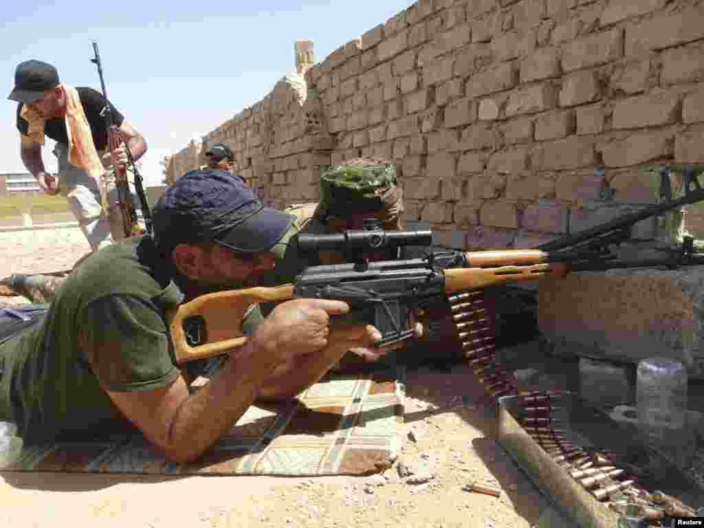 Members of Iraqi security forces are seen during a fight with Islamic State militants on the outskirts of Ramadi, Sept. 14, 2014.