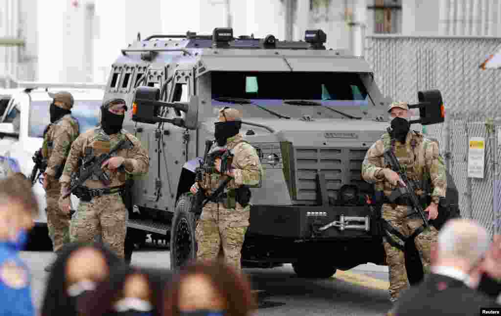 Security forces guard the area before the crew of a SpaceX Falcon 9 rocket departs for the launch pad for the first operational NASA commercial crew mission at Kennedy Space Center in Cape Canaveral, Florida, Nov. 15, 2020.