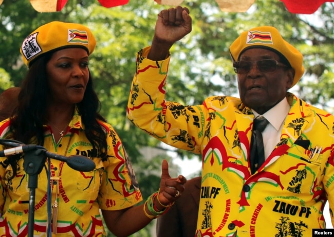 FILE - President Robert Mugabe and his wife, Grace, attend a rally of his ruling ZANU-PF party in Harare, Zimbabwe, Nov. 8, 2017.