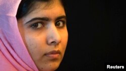 Malala Yousafzai, the Pakistani girl who was shot on a school bus by the Taliban last October for campaigning on the education of girls, sits on the sidelines of a news conference convened by 'A World at School' in New York, Sept. 23, 2013. 