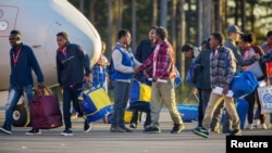 Eritrean migrants arrive at Lulea airport, Kallax, Sweden, having flown from Rome's Ciampino airport, October 9, 2015.