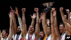 Spain' s Felipe Reyes holds the cup while teammates celebrate after winning the Eurobasket European Championship final between Spain and Lithuania in Lille, northern France, Sunday, Sept. 20, 2015.