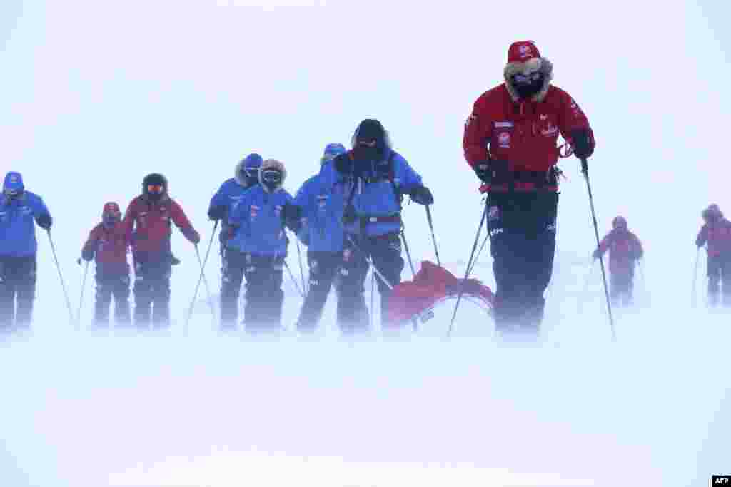 Photo issued by Walking with the Wounded (WWTW) shows Britain's Prince Harry (R), partron of Team UK in the South Pole Allied Challenge 2013 expedition, pulling the pulk which is guiding US team member Ivan Castro, who is blind, during ski training in Novo, Antarctica, ahead of a charity walk to the South Pole.