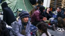 Migrant rest inside a logistics center at the checkpoint "Kuznitsa" at the Belarus-Poland border near Grodno, Belarus, Nov. 23, 2021.