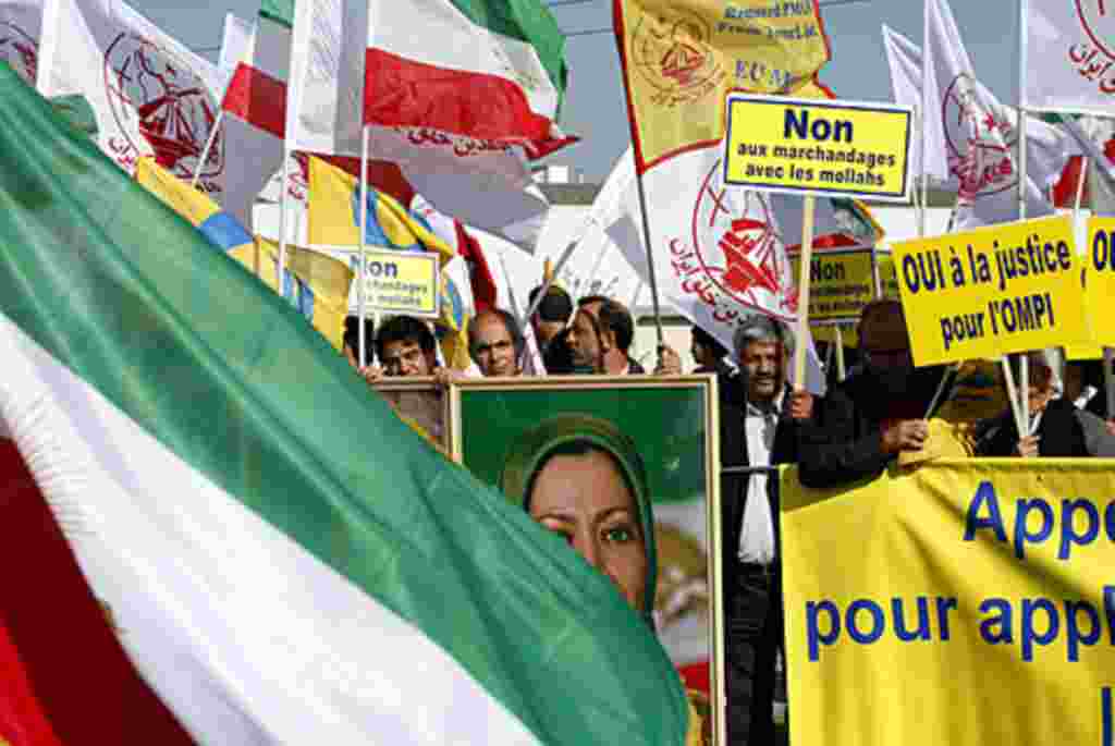 Iranian dissidents wave their national flag and various Islamic flags during a demonstration, July 10, 2008, in front of the European Parliament in Strasbourg, France, to have the People's Mujahedeen Organization of Iran removed from the EU terror list