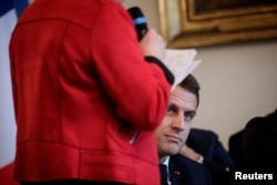 French President Emmanuel Macron attends a meeting with the cities mayors of the Saone-et-Loire department, as part of the 'Great National Debate' designed to find ways to calm social unrest of the Yellow Vests movement, in Autun, Feb. 7, 2019.