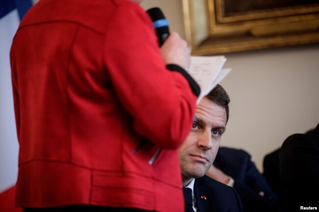 French President Emmanuel Macron attends a meeting with the cities mayors of the Saone-et-Loire department, as part of the 'Great National Debate' designed to find ways to calm social unrest of the Yellow Vests movement, in Autun, Feb. 7, 2019.