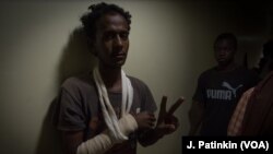 Wounded protester Mohmoud Abdulla flashes a peace sign while hiding in a corridor at Royal Care Hospital as Rapid Support Forces surrounded the building, in Khartoum, Sudan, June 4, 2019.