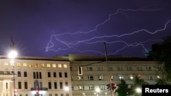 FILE - Lightning is seen over the U.S. Embassy in Berlin, Germany, Aug. 9, 2018. 