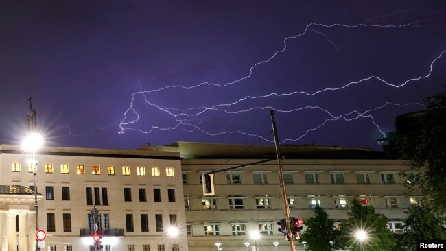 FILE - Lightning is seen over the US Embassy in Berlin, Germany, Aug. 9, 2018.