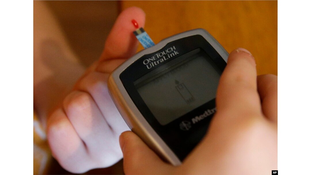FILE - A diabetic has his blood sugar level checked.