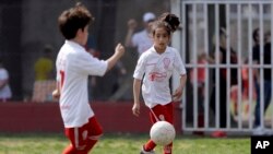 In this Sept. 8, 2018 photo, Candelaria Cabrera controls the ball during a match between her team Huracan and Alumni, in Chabaz, Argentina.