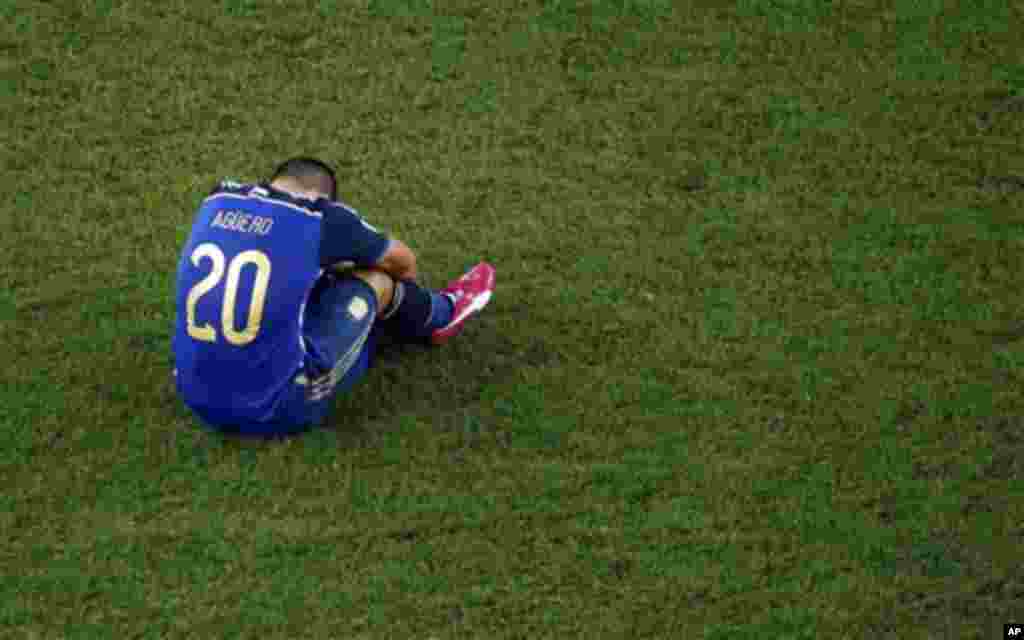 Argentina's Sergio Aguero sits on the pitch at the end of the World Cup final soccer match between Germany and Argentina at the Maracana Stadium in Rio de Janeiro, Brazil, Sunday, July 13, 2014. Mario Goetze volleyed in the winning goal in extra time to g