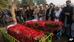 Siraj-ul-Haq, fourth right, chief of Pakistan's religious party Jammat-e-Islami, leads a funeral prayer for a student killed in Tuesday's Taliban attack on a school in Peshawar, Pakistan, Dec. 17, 2014. (AP Photo/Mohammad Sajjad) 