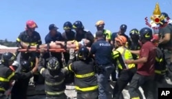 Eleven-year-old Ciro is carried on a stretcher after being rescued by Italian firefighters from the rubble of a collapsed building in Casamicciola, on the island of Ischia, near Naples, Italy, Aug. 22, 2017, a day after a 4.0-magnitude quake hit the Italian resort town.