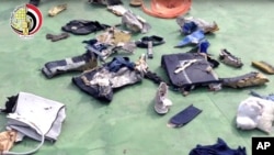 FILE - This file still image taken from video posted Saturday, May 21, 2016, on the official Facebook page of the Egyptian Armed Forces spokesman shows some personal belongings and other wreckage from EgyptAir flight 804 in Egypt. 