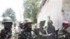 Somali president Sheik Sharif Sheik Ahmed (2nd L) comes to see where police displayed the bodies of four al-Shabab fighters killed during fighting in Mogadishu, Mar 22 2011