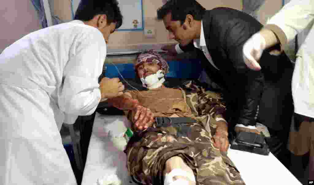 Afghan medics help an injured man receive treatment at a hospital after a suicide attack in Faryab province, north of Kabul, July 22, 2015.