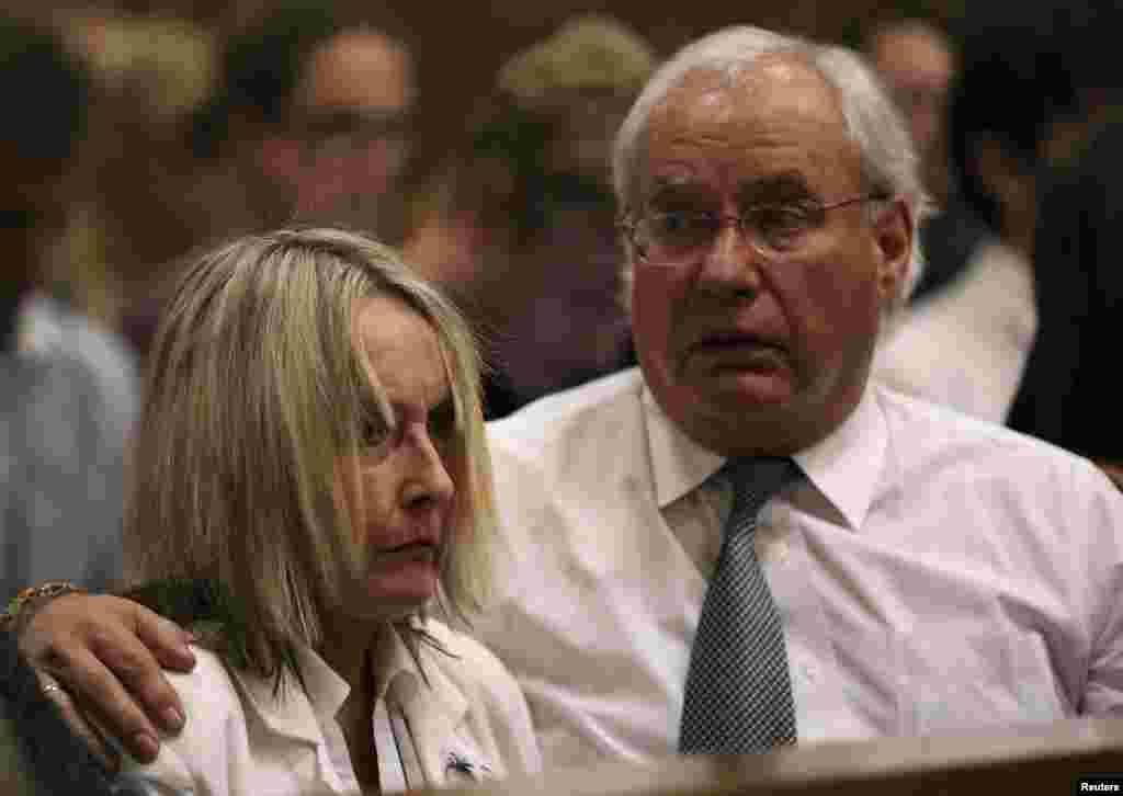 Jane Steenkamp, Reeva Steenkamp's mother is comforted by a relative after her dead daughter's picture was shown on screen during the trial of Oscar Pistorius at the North Gauteng High Court in Pretoria, April 9, 2014. 