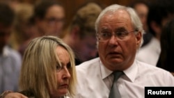 Jane Steenkamp, Reeva Steenkamp's mother is comforted by a relative after her dead daughter's picture was shown on screen during the trial of Oscar Pistorius at the North Gauteng High Court in Pretoria, April 9, 2014.