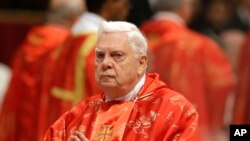 FILE - In this Tuesday, March 12, 2013 file photo, Cardinal Bernard Law attends a Mass for the election of a new pope celebrated by Cardinal Angelo Sodano, not pictured, inside St. Peter's Basilica, at the Vatican. 