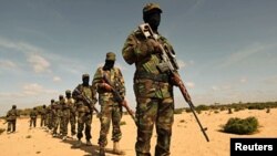 Members of Somalia's al-Shabaab militant group parade during a demonstration to announce integration with al Qaida, in Elasha, south of the capital Mogadishu, February 13, 2012.