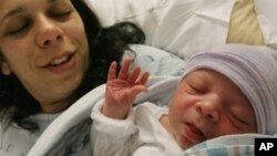 Maria Iozia holds newborn son Dio Anthony Flore, Queens, New York, 2007 (file photo).