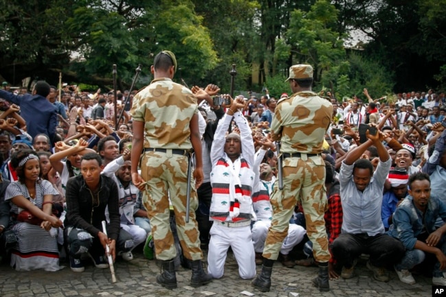 FILE - Ethiopian soldiers try to stop protesters in Bishoftu, during a declared state of emergency, in the Oromia region of Ethiopia, Oct. 2, 2016.