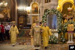 Russian Orthodox Patriarch Kirill, center, conducts a service in front of the the icon Mother of God Reigning, at second right, at the Christ the Savior Cathedral in Moscow, Russia, Feb. 19, 2017. The requiem was in memory of the victims of the faith, in connection with the centennial of the February Revolution in Russia in 1917.