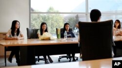 FILE - Students attend a meeting of a Chinese scholars association on the campus of the University of Connecticut in Storrs. 