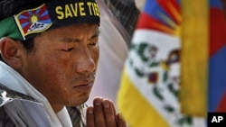 Tears roll down the cheeks of a Tibetan exile as he listens to a speaker during a protest outside the Chinese Embassy on the first day of Tibetan New Year, in New Delhi, India, February 22, 2012.