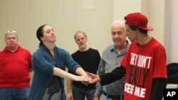 Army veteran Carissa DiPietro takes the hand of Iraq war veteran Mike Mitchels while rehearsing for "Julius Caesar" in Milwaukee. A group of actors is using William Shakespeare’s plays to help veterans with emotional and addiction issues heal, Sept. 27, 2015.