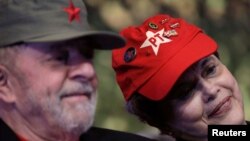 FILE - Former Brazilian President Luiz Inacio Lula da Silva, left, and Former Brazilian President Dilma Rousseff are seen wearing party caps during the opening ceremony of the national congress of the Workers' Party in Brasilia, Brazil, June 1, 2017. 