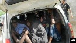 Students of the Garissa University College take shelter in a vehicle after fleeing from an attack by gunmen in Garissa, Kenya, April 2, 2015.