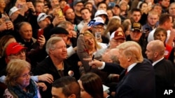 People greet Republican presidential candidate Donald Trump, bottom right, after he spoke at a rally at the Surf Ballroom in Clear Lake, Iowa, Jan. 9, 2016.