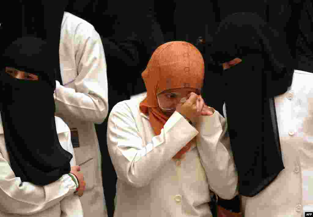 A Yemeni university student wipes her eyes at the School of Medicine in Sana&#39;a during the commemoration of the first anniversary of suicide attack that targeted the Yemeni Defense Ministry, killing many that worked in a hospital within the complex.