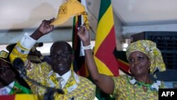 FILE - Zimbabwean President and Zanu PF leader Robert Mugabe (L) and his wife Grace greets delegates during the official opening of the 6th Peoples Congress of Zanu-PF in Harare, Dec. 4, 2014.