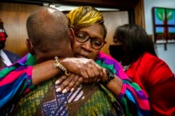 Ahmaud Arbery's mother, Wanda Cooper-Jones, is hugged by a supporter after the jury convicted Travis McMichael in the trial of McMichael, his father, Greg McMichael, and neighbor, William "Roddie" Bryan, Nov. 24, 2021, in the Glynn County Courthouse in Br