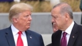 President Donald Trump, left, talks to Turkish President Recep Tayyip Erdogan, right, as they tour the new NATO headquarters in Brussels, Belgium, July 11, 2018. 