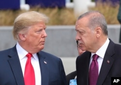 FILE - President Donald Trump talks to Turkish President Recep Tayyip Erdogan at NATO headquarters in Brussels, July 11, 2018.