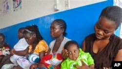 In this 2014 photo, mothers wait on line for their children to be vaccinated by heath workers at the Pipeline Community Health Center, situated on the outskirts of Monrovia, Liberia. (Associated Press)