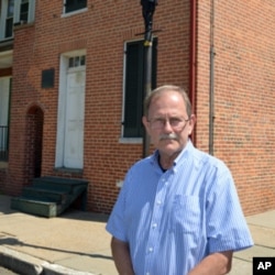 Curator Jeff Jerome stands outside of the house where Edgar Allan Poe lived while he was in Baltimore.