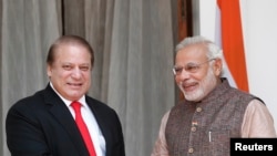 India's Prime Minister Narendra Modi and his Pakistani counterpart Nawaz Sharif smile before the start of their bilateral meeting in New Delhi, May 27, 2014.