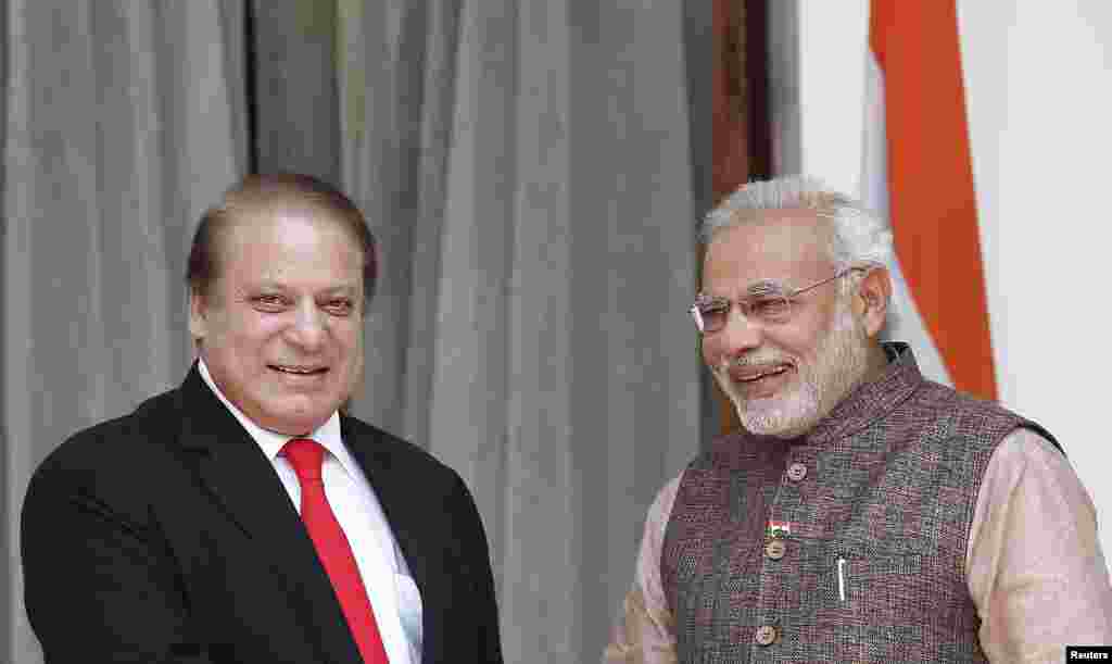 India's Prime Minister Narendra Modi and his Pakistani counterpart Nawaz Sharif smile before the start of their bilateral meeting in New Delhi, May 27, 2014.