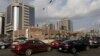 FILE - Cars queue in front of the Nigerian National Petroleum Corporation headquarters to buy fuel in Abuja, Nigeria, May 26, 2015.