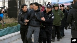 在北京法院外面拍攝“新公民運動”發起人許志永等人的外國攝影記者被警察架走。（2014年1月26日）