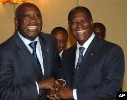 FILE - Former Ivory Coast President Laurent Gbagbo, left, and incumbent Alassane Ouattara posed for a photo before the 2010 ballot.